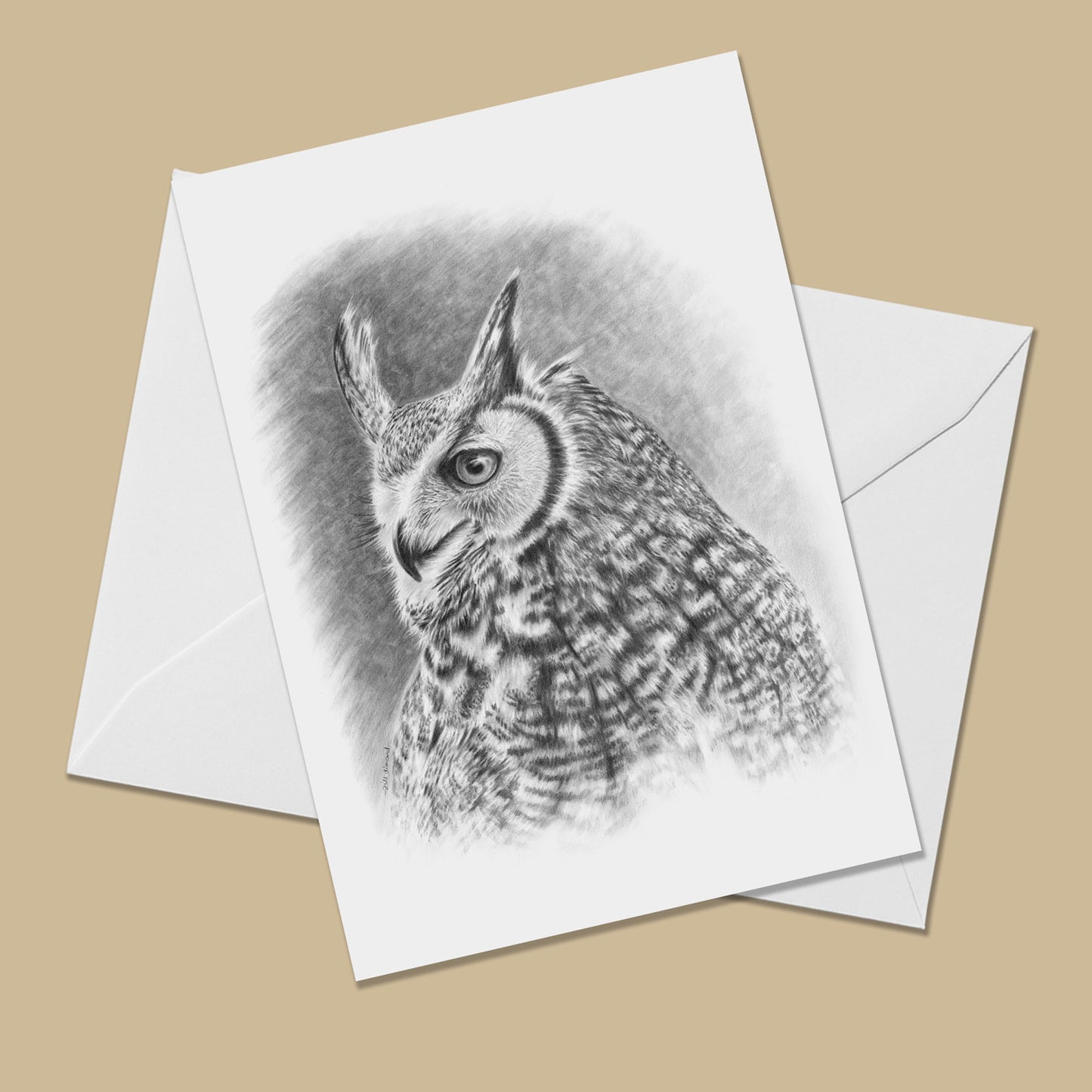 Greeting card with the image of a black and white drawing of a great horned owl on it. The card is on top of a white envelope.