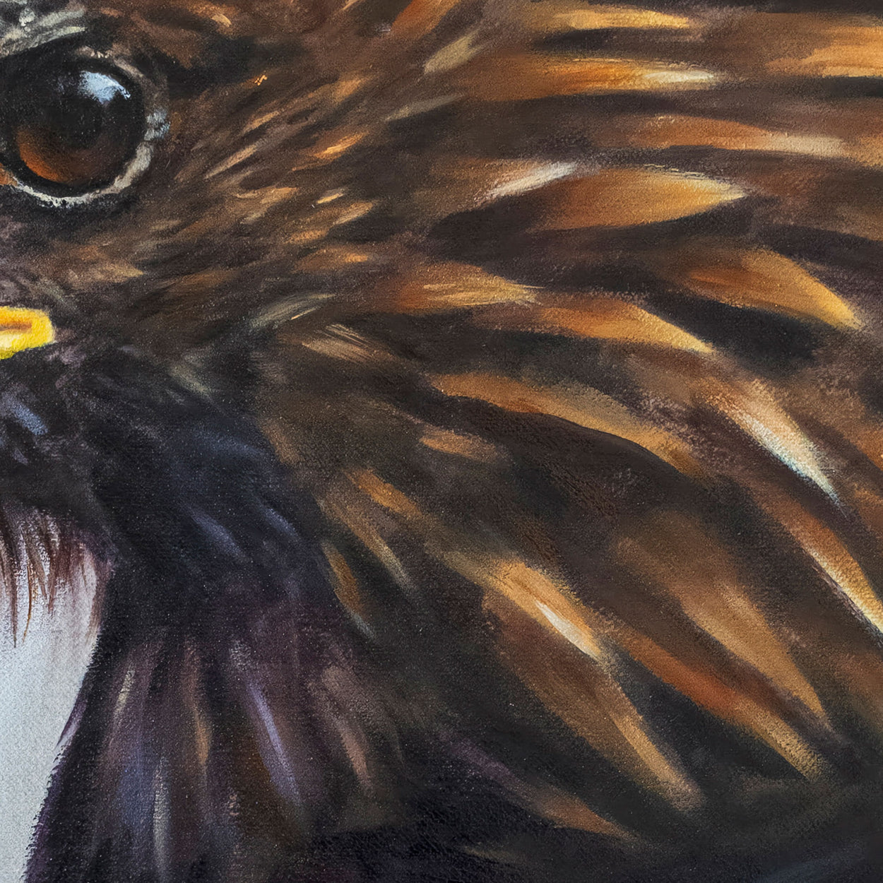 Close-up of an oil painting of golden eagle feathers.